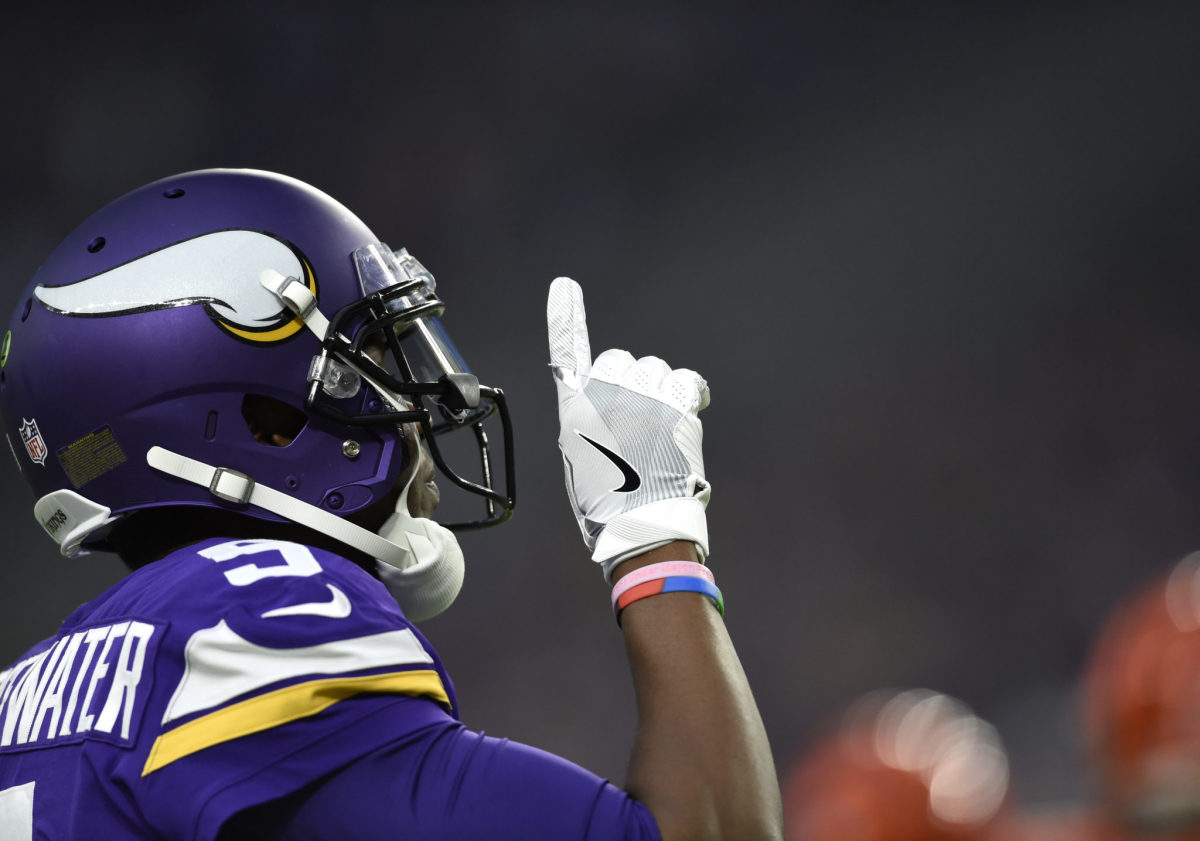 Teddy Bridgewater points to the sky during a game.