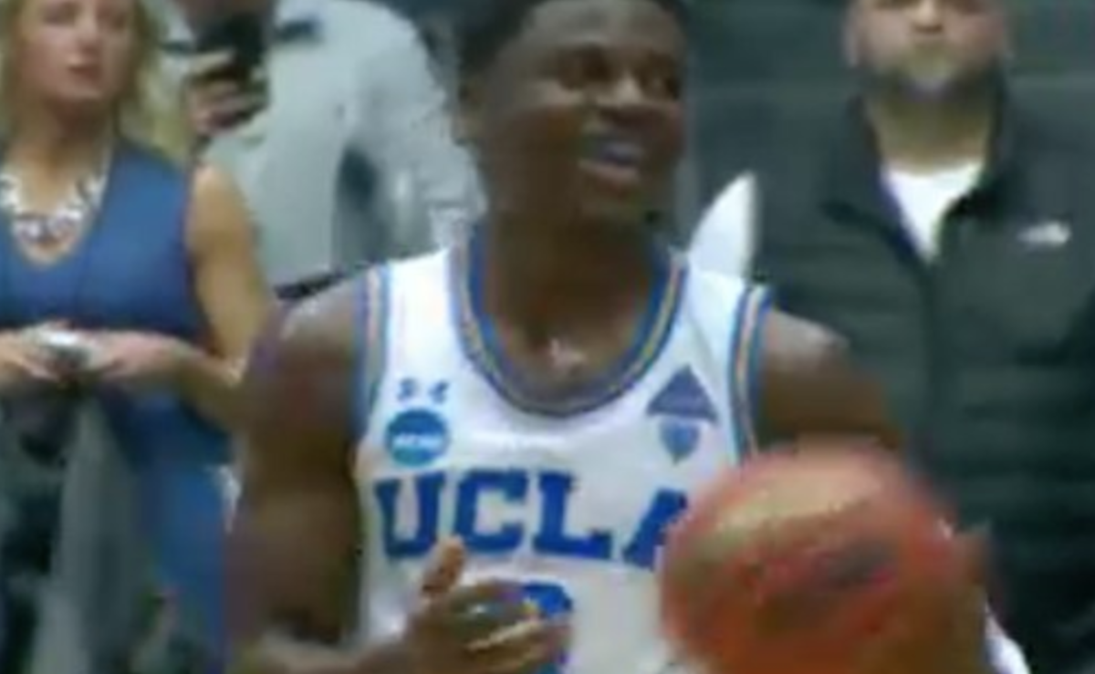 aaron holiday holds the ball during a game.