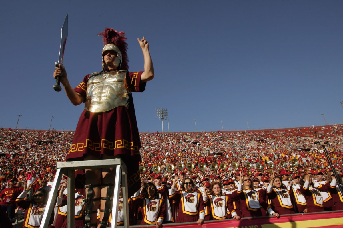 USC's mascot standing on a ladder while holding up a sword.