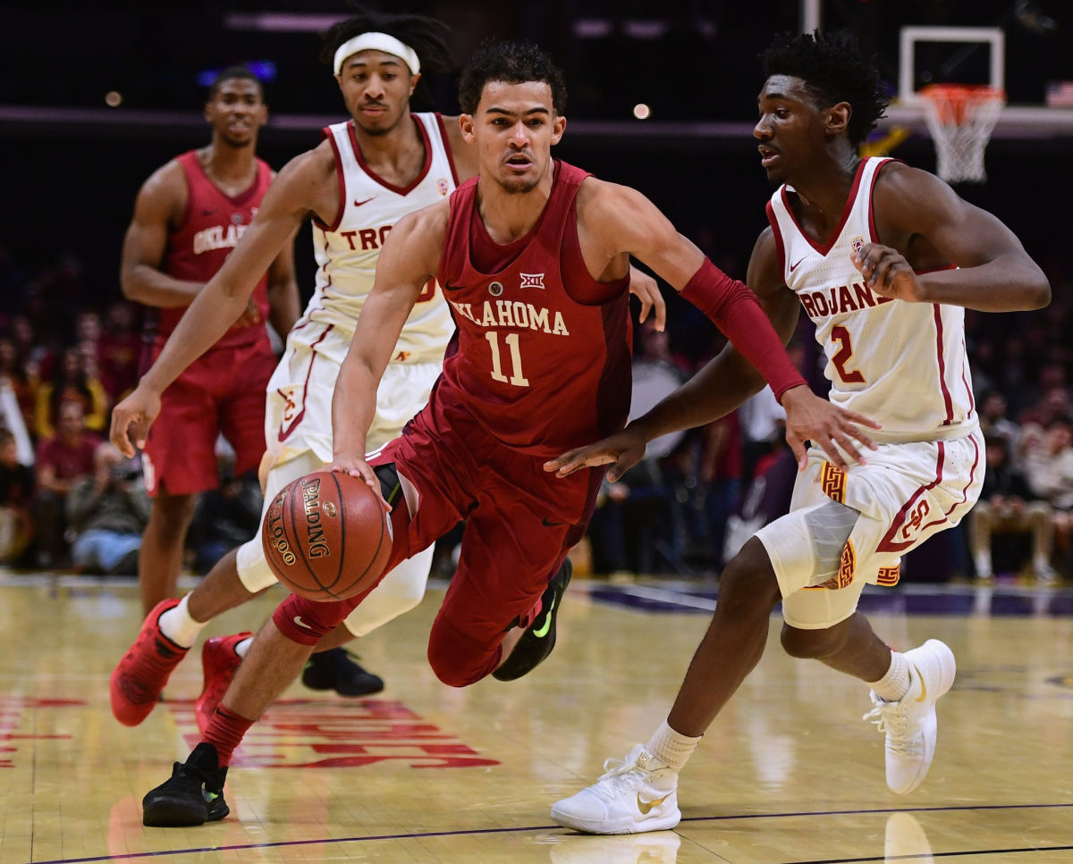 Trae Young driving to the basket in a game between Oklahoma and USC.