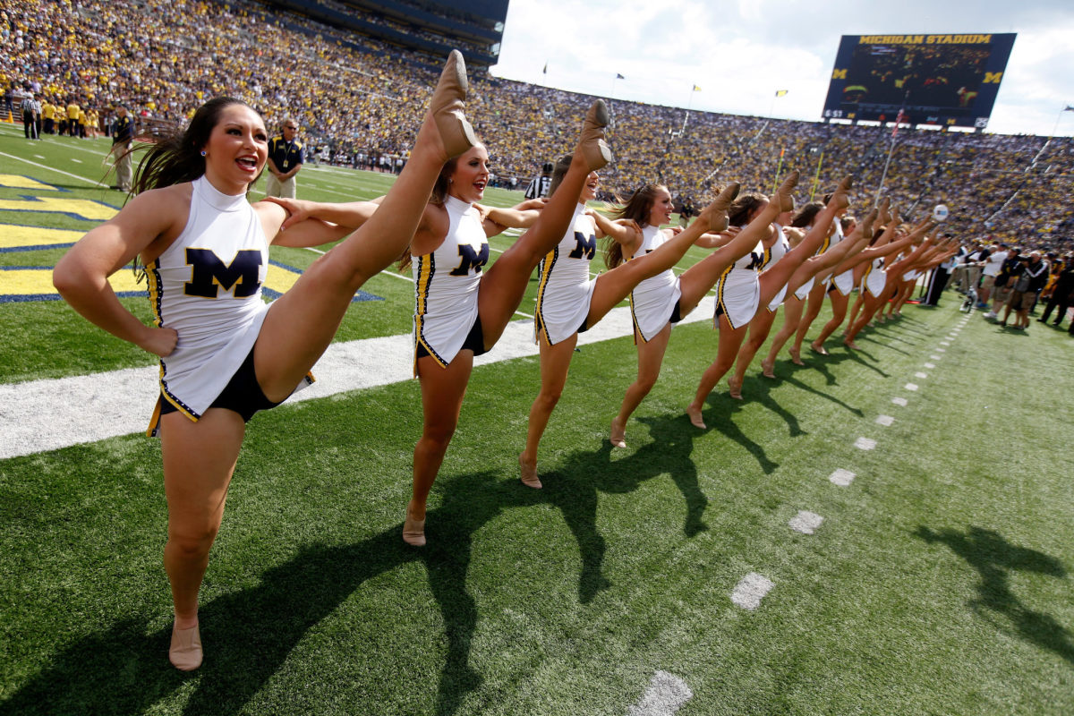 The Michigan Wolverines Cheerleaders support their team against the Brigham Young Cougars at Michigan Stadium.