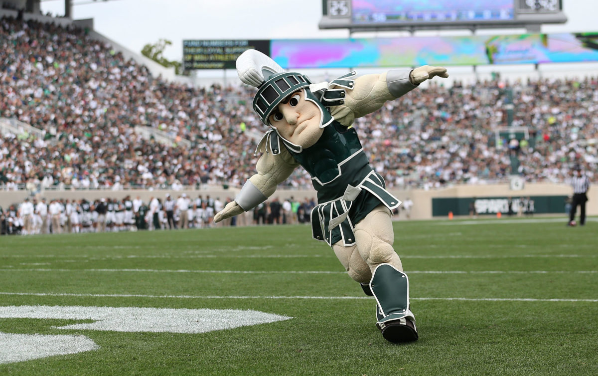 Michigan State's mascot running around on the football field.