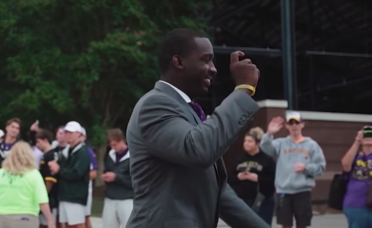 Scottie Montgomery enters the stadium ahead of his first game as ECU head coach.