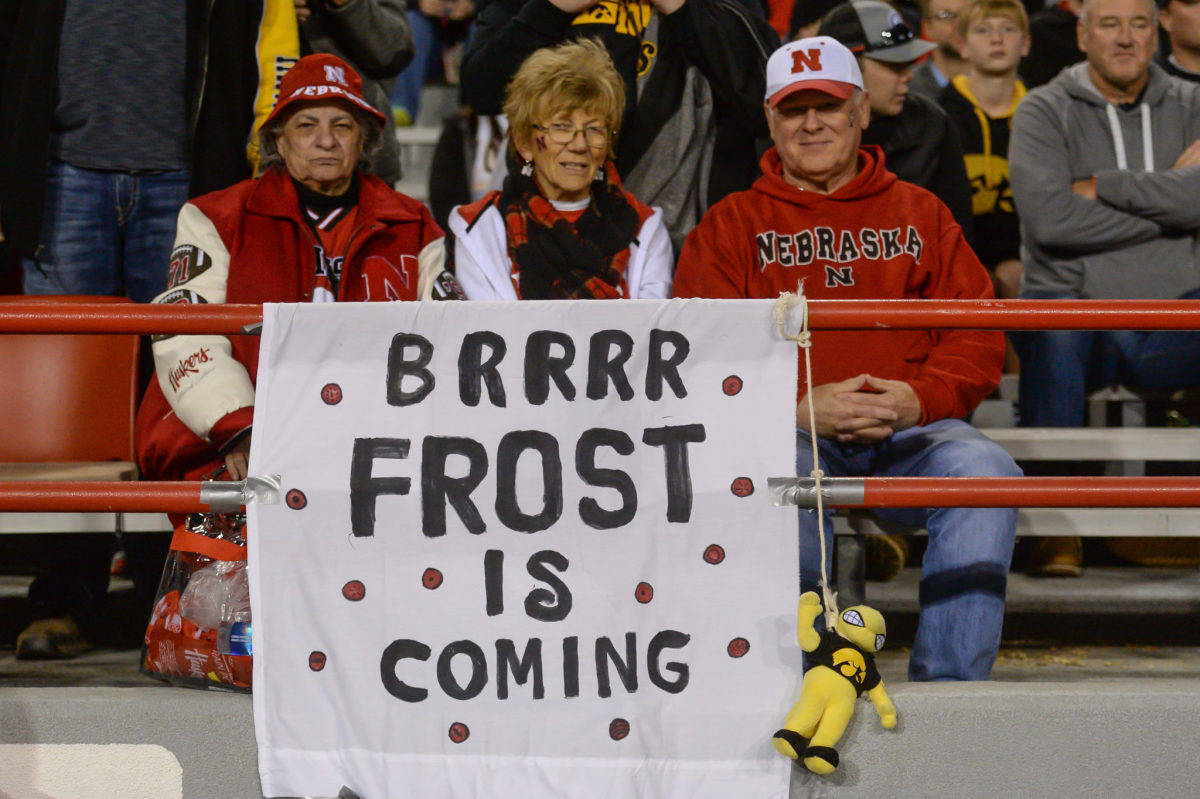Nebraska fans with sign welcoming Scott Frost.