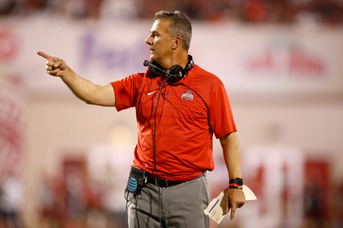 A closeup of Urban Meyer wearing an Ohio State polo during a football game.