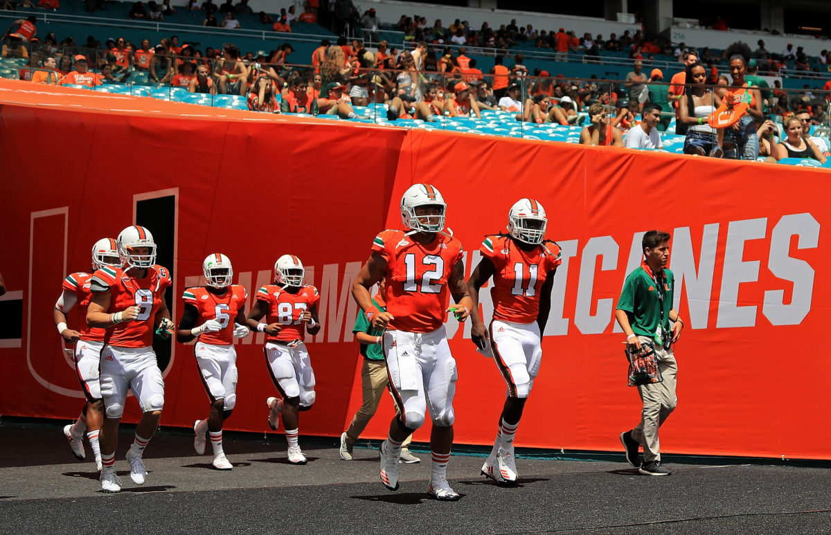 A group of Miami players take the field for a game.