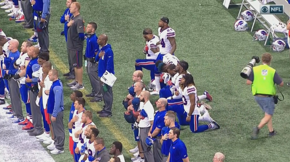 Buffalo Bills players kneel for national anthem.
