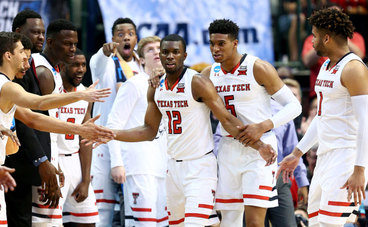DALLAS, TX - MARCH 17:  Keenan Evans #12 of the Texas Tech Red Raiders celebrates with teammates in the second half against the Florida Gators during the second round of the 2018 NCAA Tournament at the American Airlines Center on March 17, 2018 in Dallas, Texas.  (Photo by Ronald Martinez/Getty Images)
