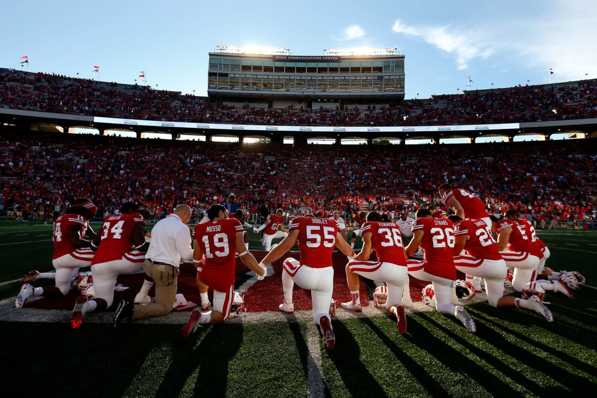 Wisconsin's players pray in a circle ahead of a game.