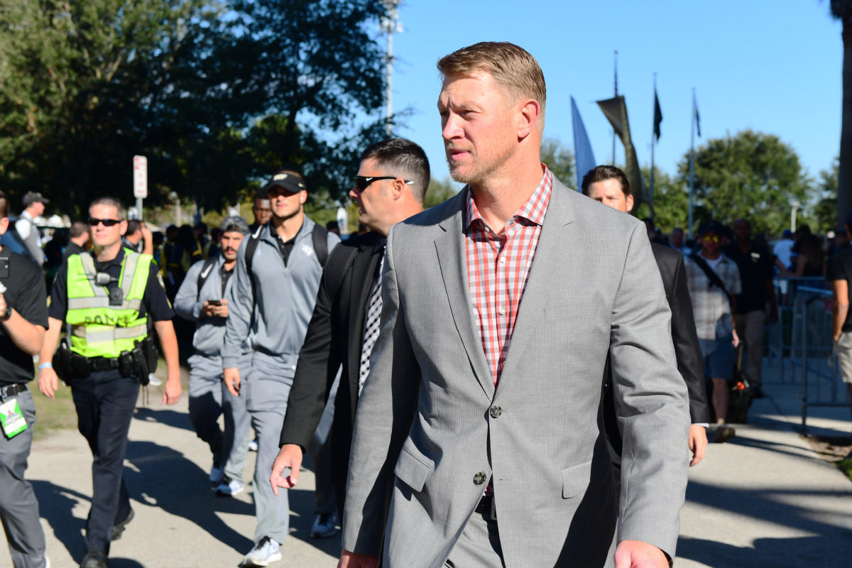 Head coach Scott Frost of the UCF Knights walks up to the stadium with his team before pregame of the 2017 AAC Championship.