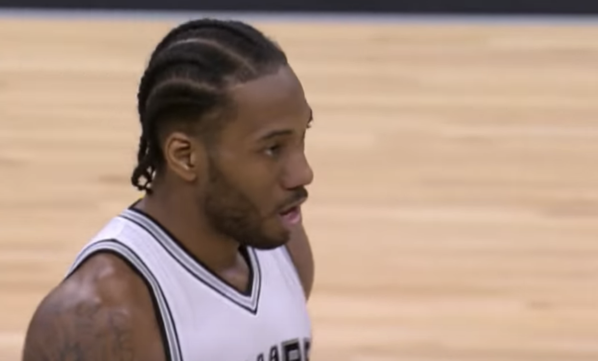 Kawhi Leonard runs up the court during a game for the Spurs.