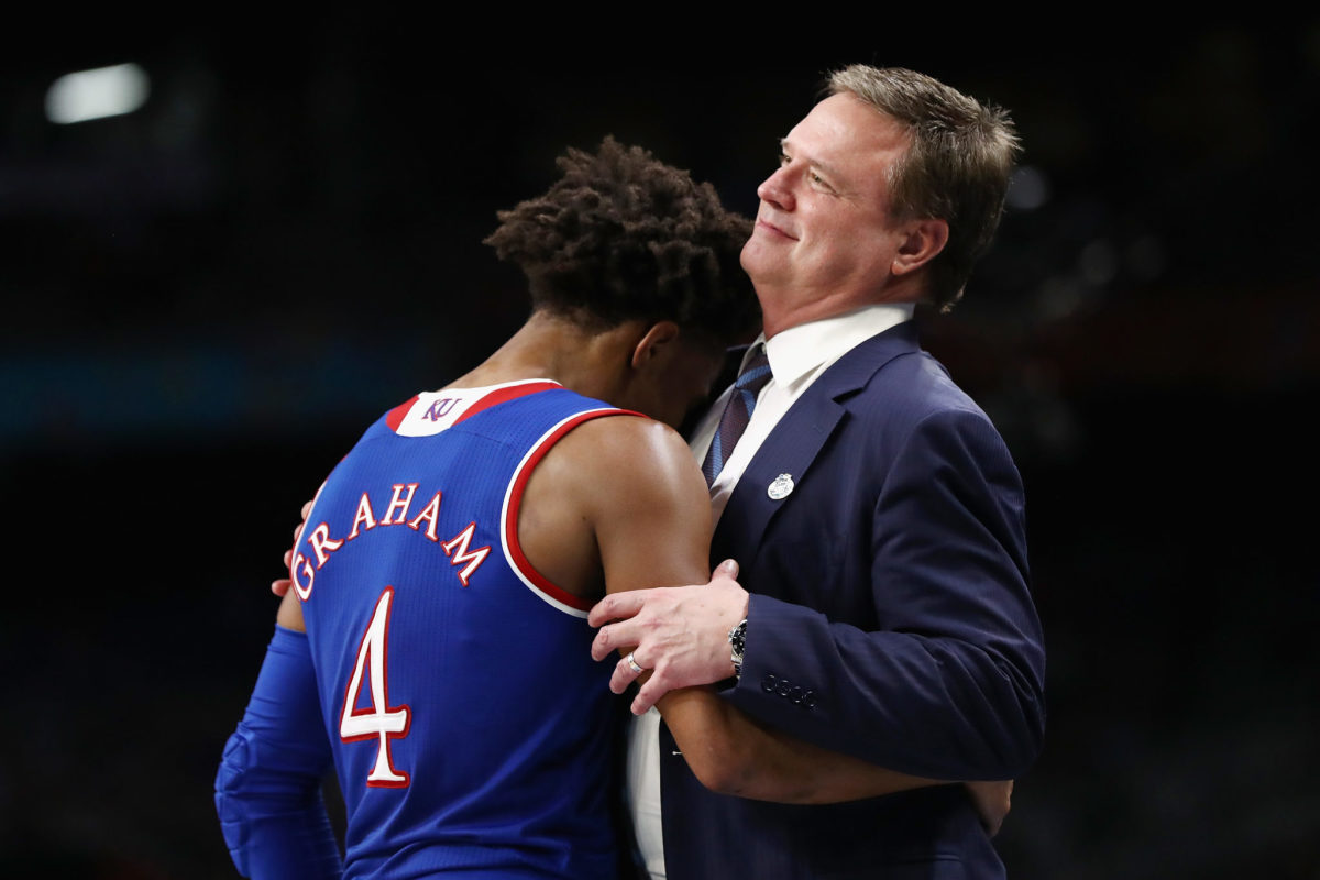Devonte' Graham crying in Bill Self's arms.
