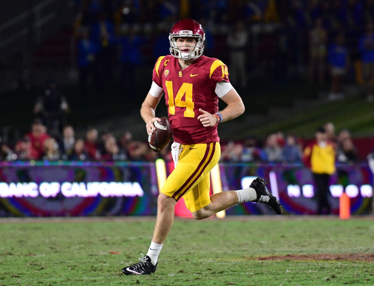 Sam Darnold #14 of the USC Trojans scrambles out of the pocket during the second quarter against the UCLA Bruins.