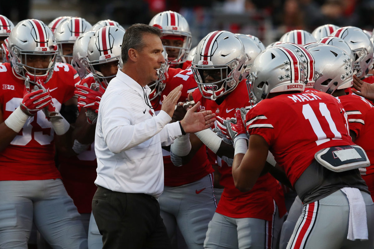 Urban Meyer interacting with Ohio State football team.