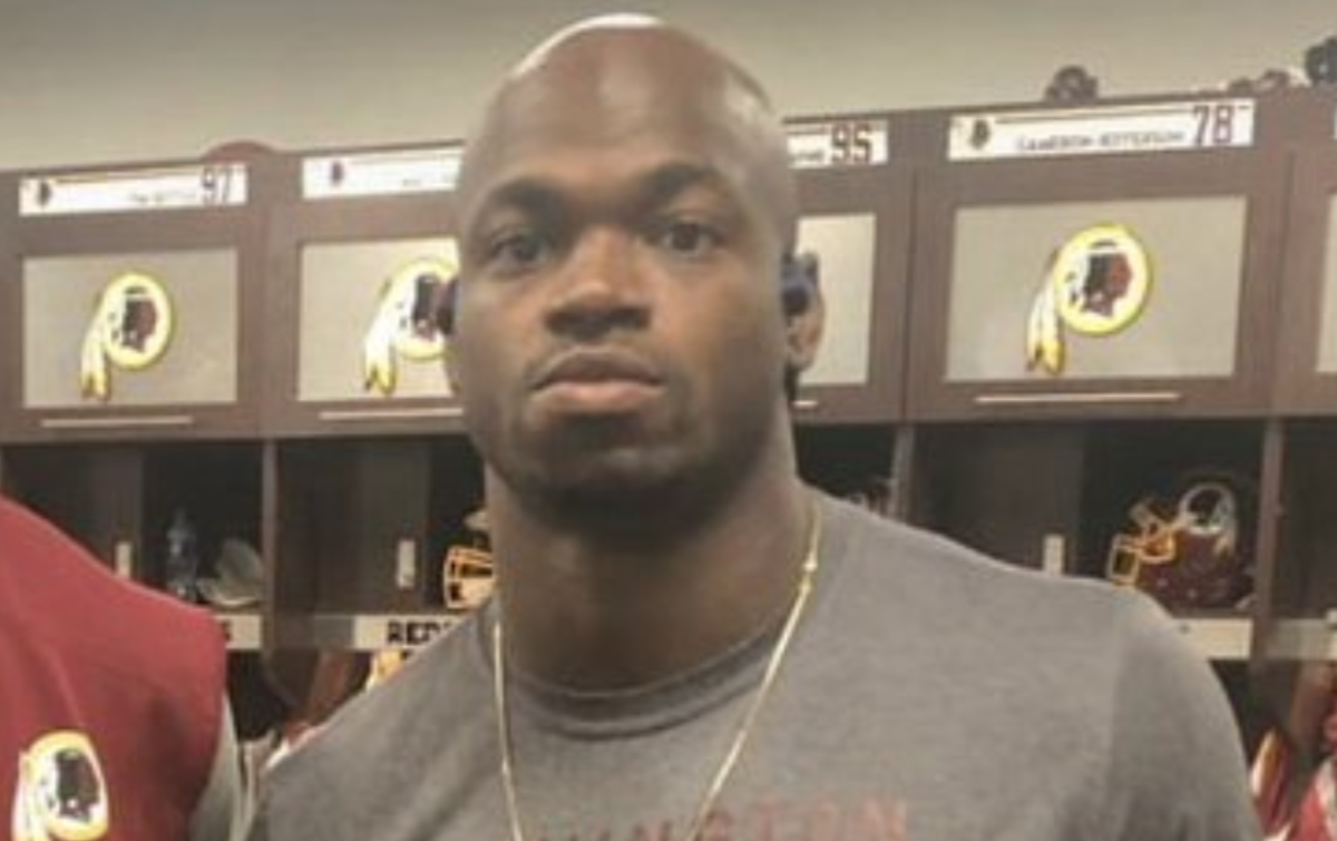 adrian peterson sports some redskins gear