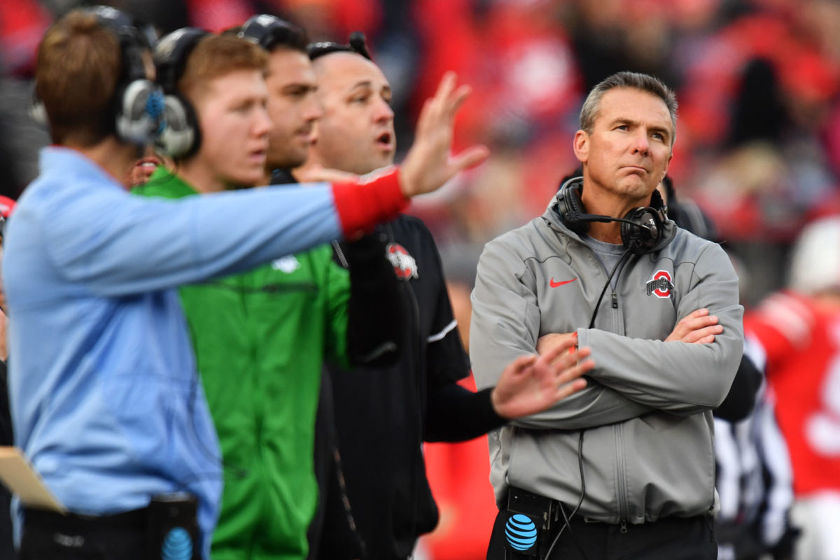 Urban Meyer looking up at the scoreboard during an Ohio State football game.