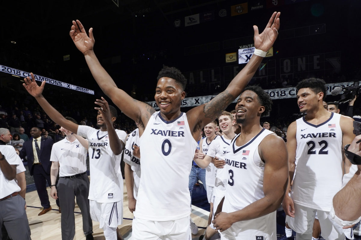 Xavier basketball players celebrate winning Big East.