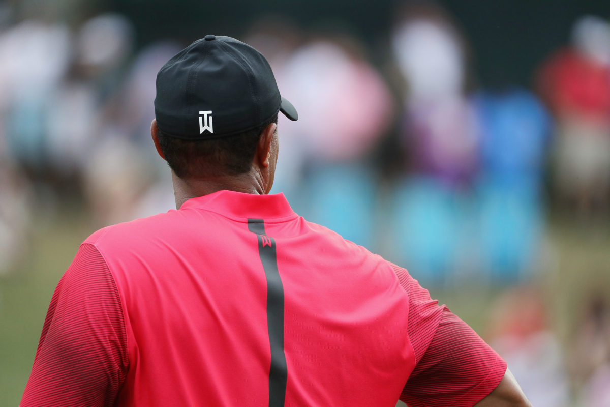 A picture of Tiger Woods taken from behind.