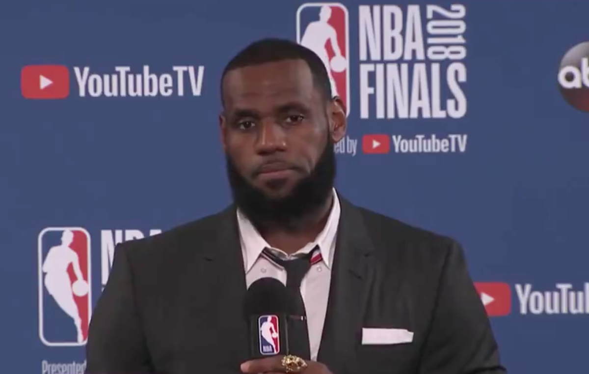 LeBron James walks out of a press conference.