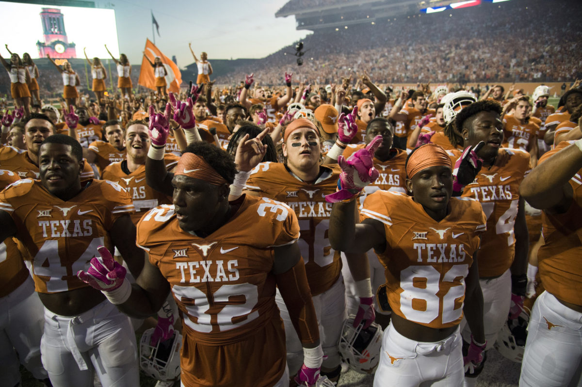 Texas Longhorns football players celebrate after a win