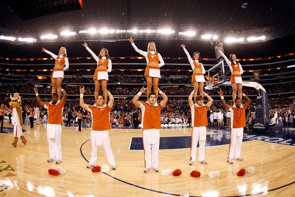 Texas Longhorns cheerleaders performing during a basketball game.