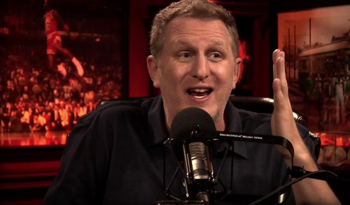 Michael Rapaport laughs into the microphone.