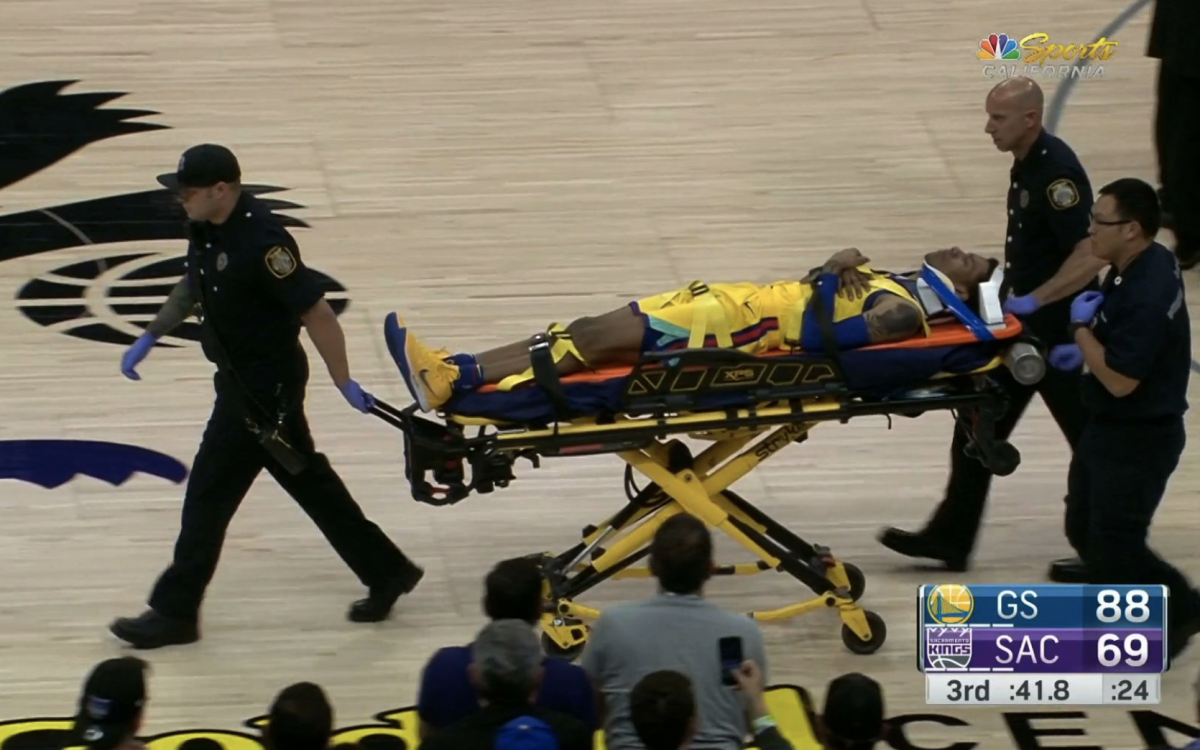 Golden State Warriors player Patrick McCaw is carted off the court on a stretcher.