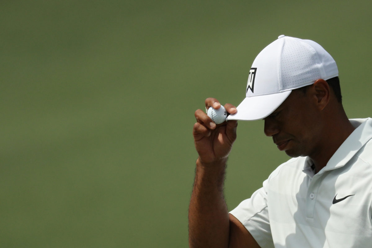 Tiger Woods tipping his hat.