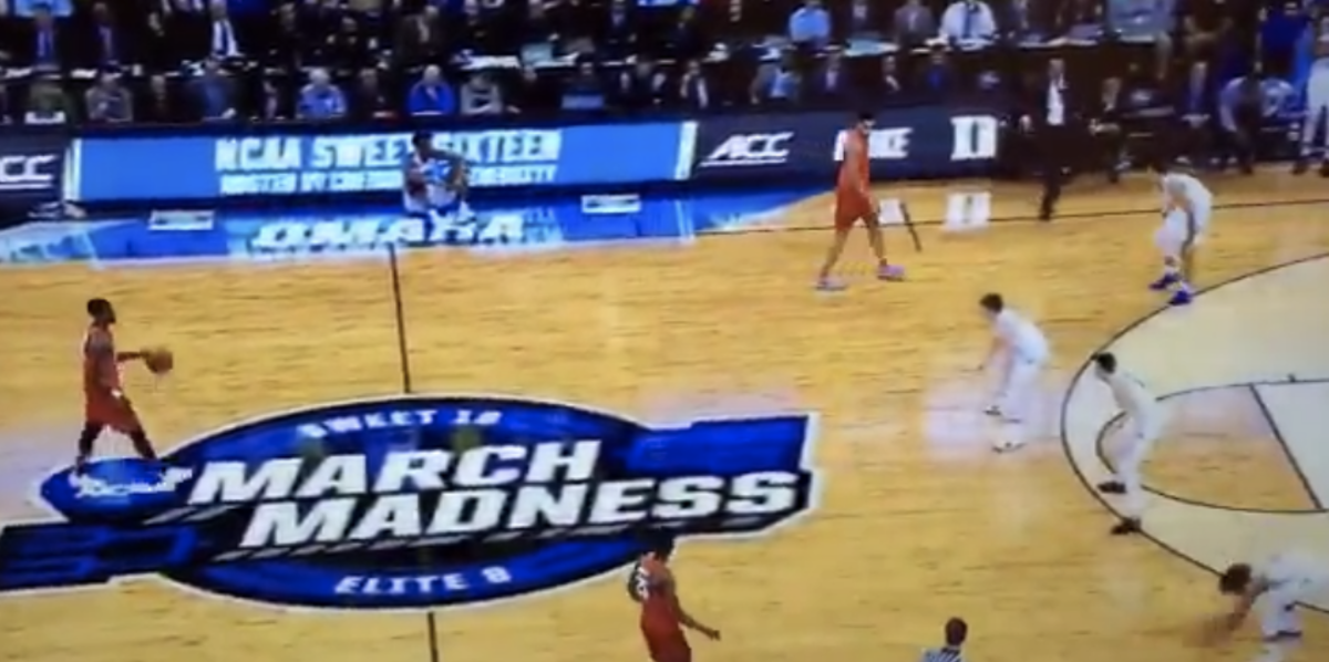 Duke's players slap the floor while playing a zone against Syracuse.