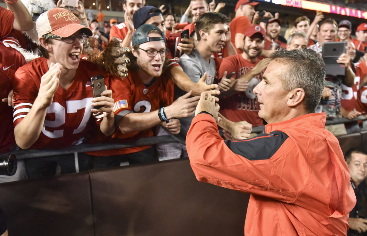 Urban Meyer interacting with Ohio State fans.