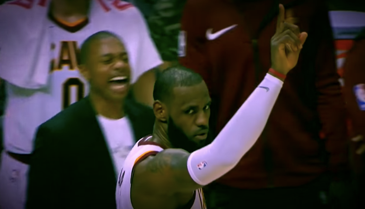 lebron james waves at the crowd during a cavs game