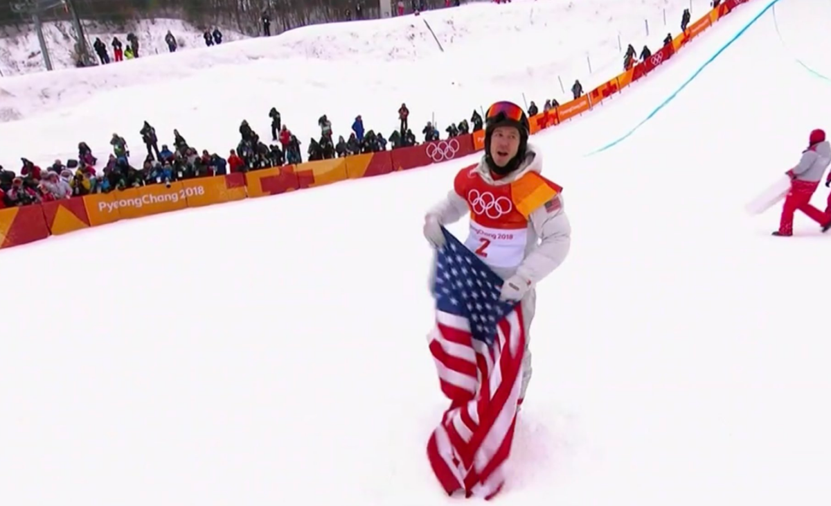 Shaun White holding the American flag.