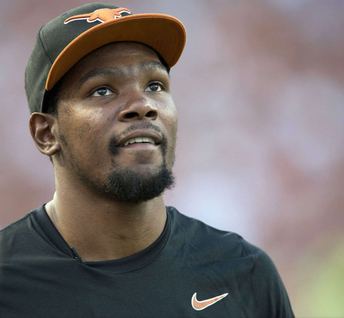 Kevin Durant wearing a Texas Longhorns hat at a Texas game.