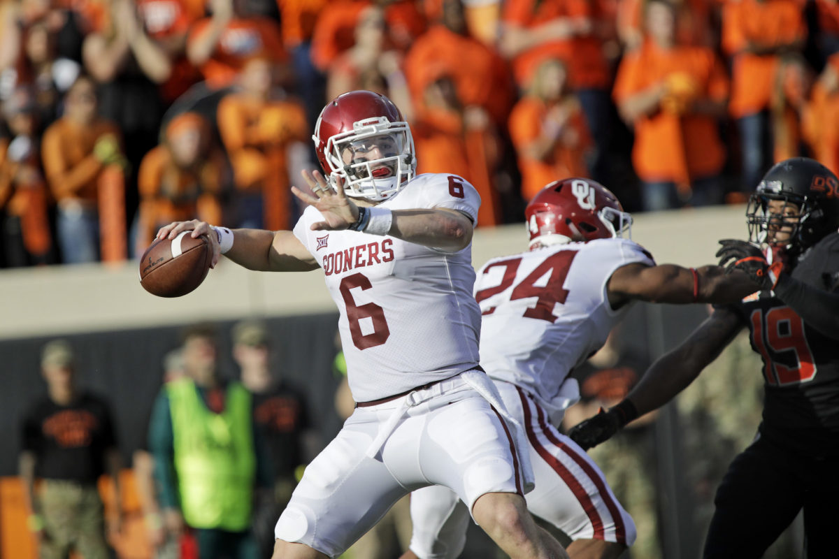 Baker Mayfield winding up to throw the football.