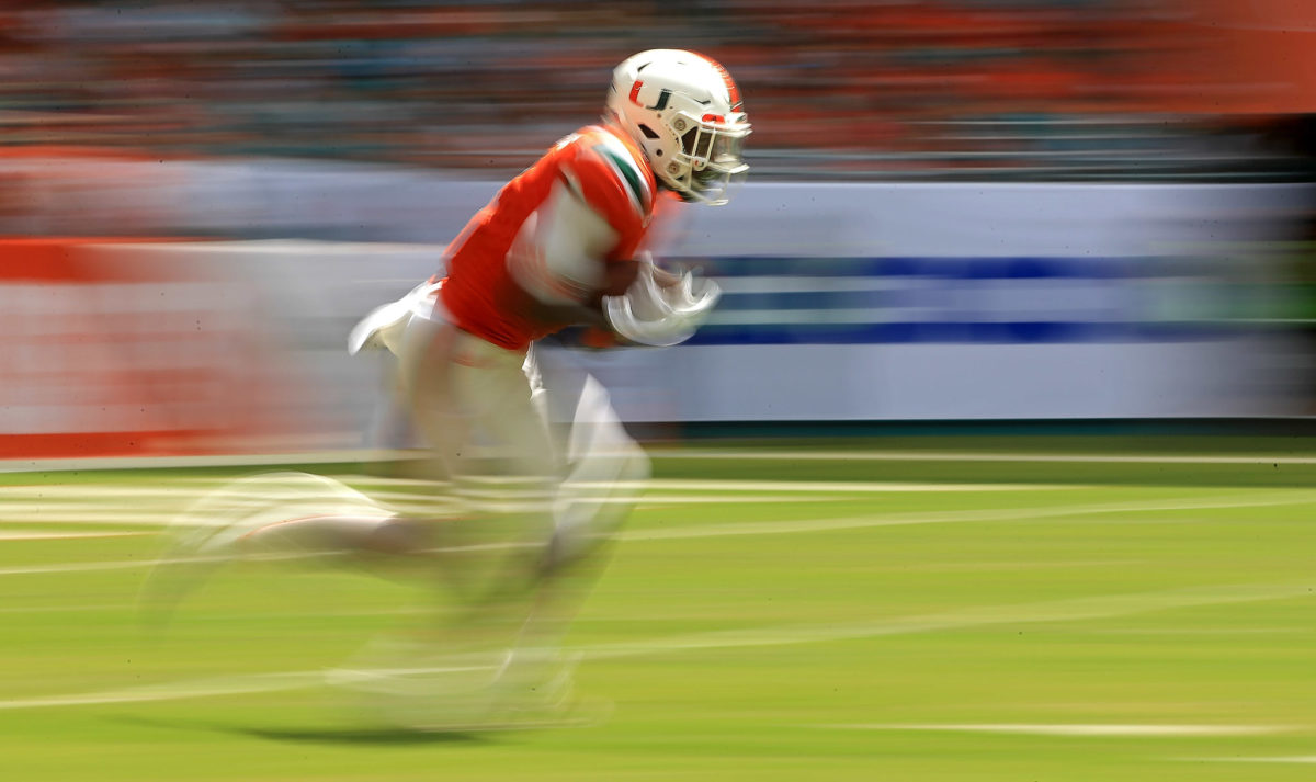 Malek Young of Miami returns a kickoff during a game.
