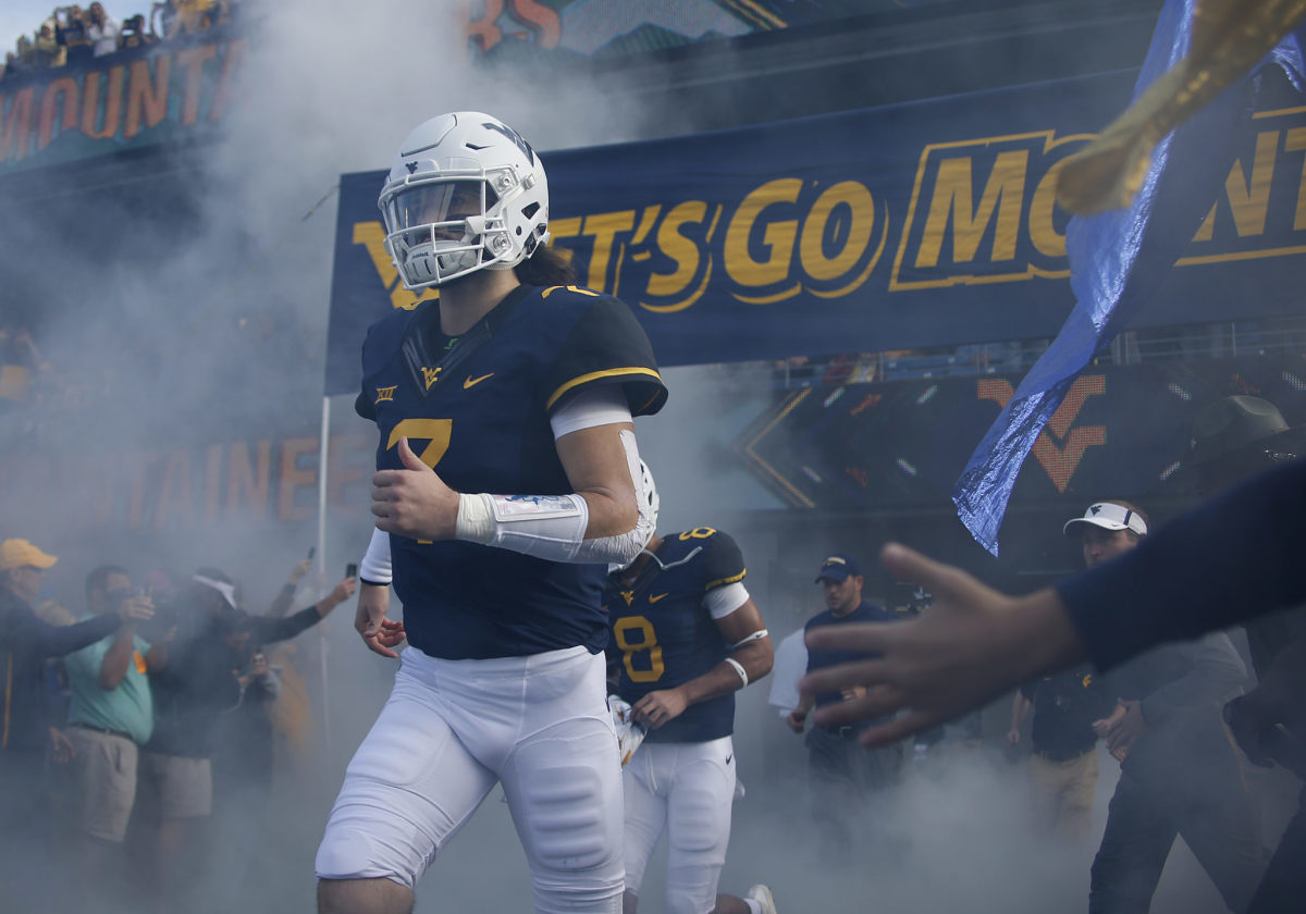 Will Grier of the West Virginia Mountaineers takes the field against the Iowa State Cyclones at Mountaineer Field.