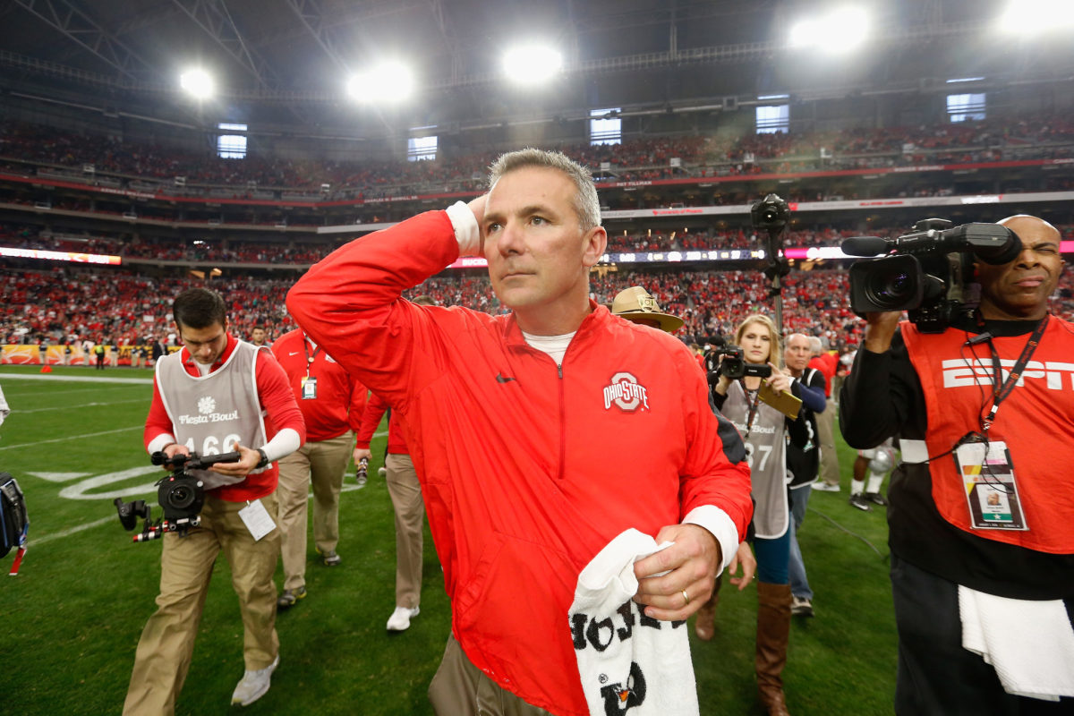 Urban Meyer walking off the field after an Ohio State football game.