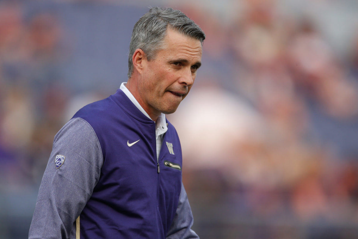 Chris Petersen looks on prior to a game.