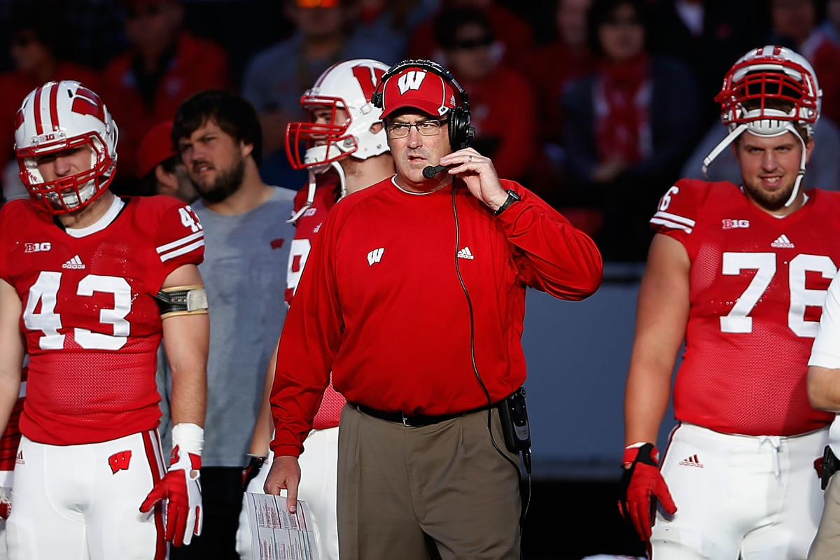 Paul Chryst leads Wisconsin onto the field.