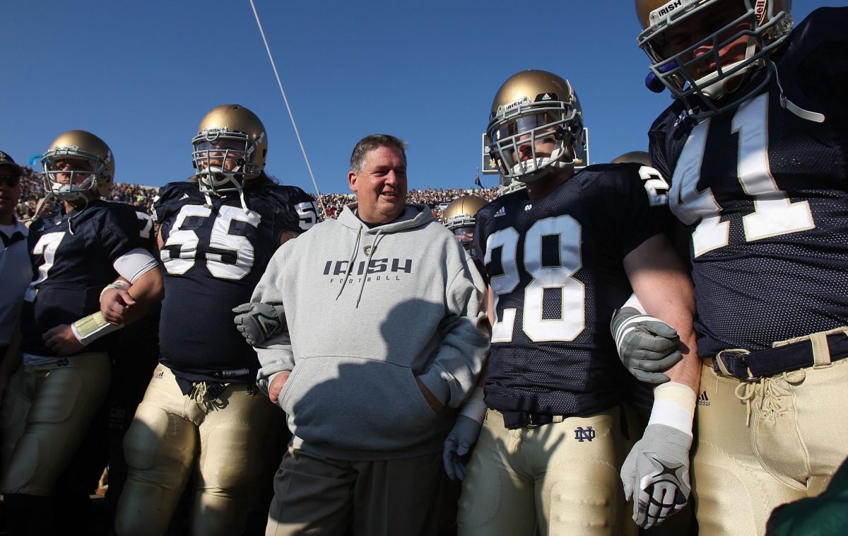 Charlie Weis locking arms with Notre Dame players.