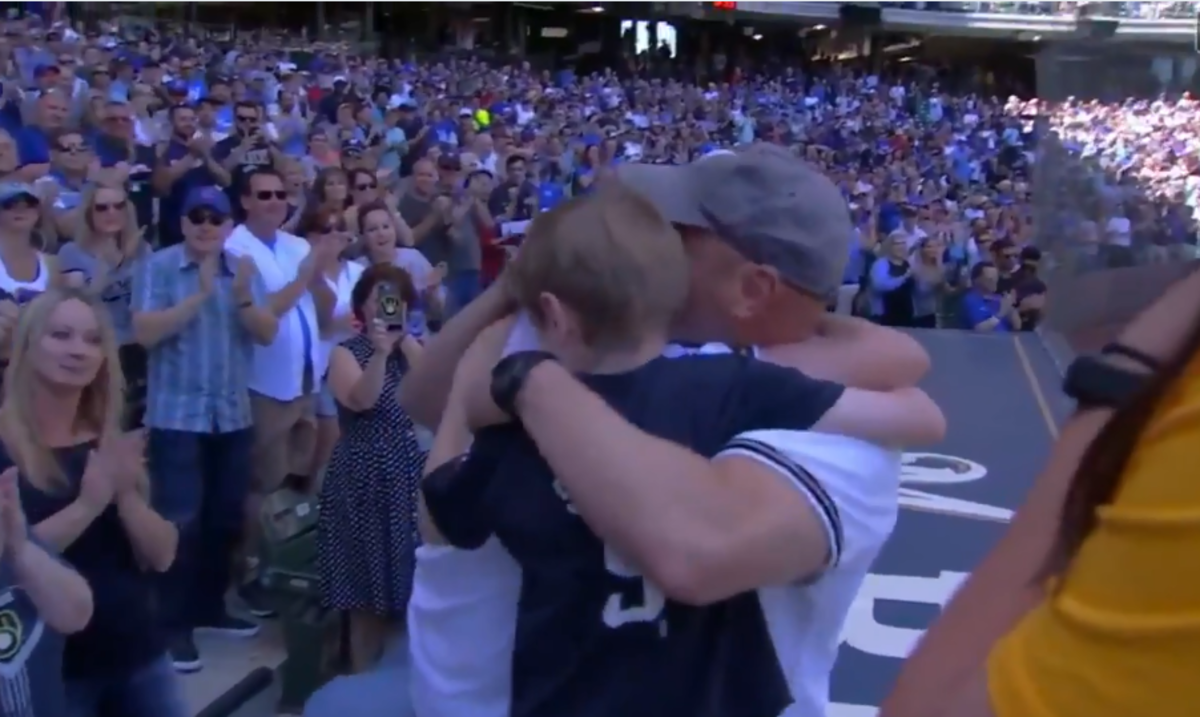 Father surprises his family at a baseball game.