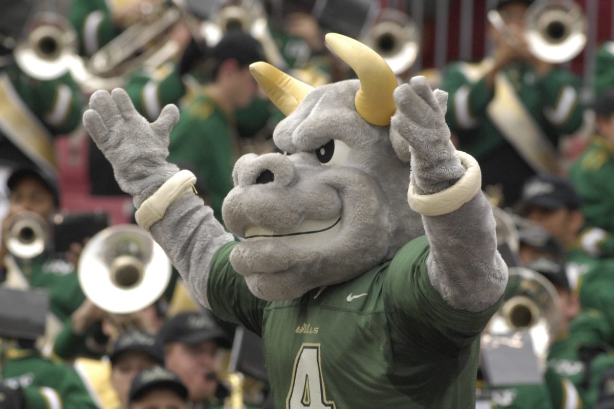 The USF mascot raising its arms.