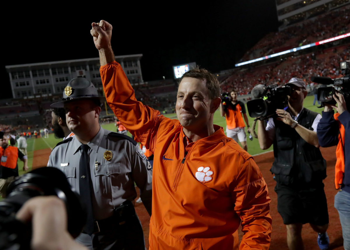 Head coach Dabo Swinney of the Clemson Tigers celebrates after defeating the North Carolina State Wolfpack 38-31 at Carter Finley Stadium.