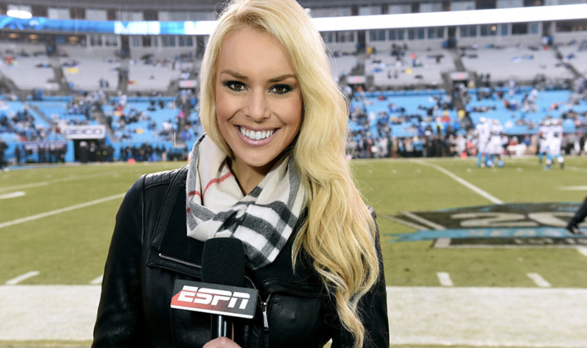 Britt McHenry smiling on the sideline.