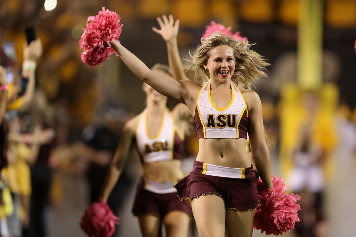 Arizona State Sun Devils cheerleaders take the field before the first half of the college football game against the Washington State Cougars at Sun Devil Stadium.
