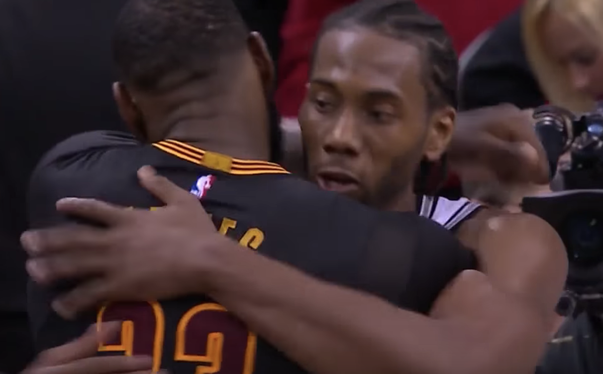 LeBron James hugs Kawhi Leonard after a game.