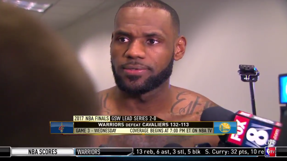 LeBron speaks to the media shirtless.
