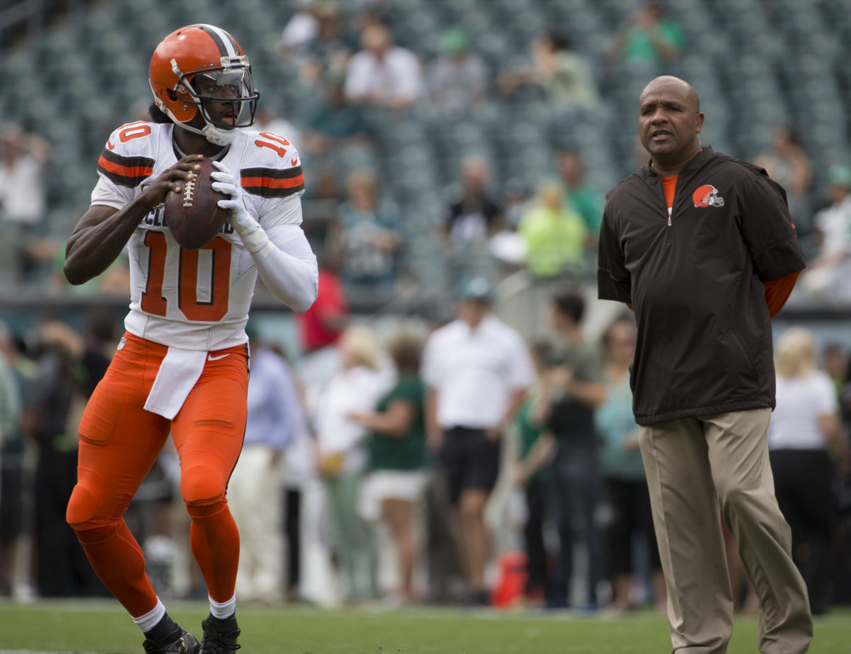 Robert Griffin III throwing passes as Hue Jackson watches.