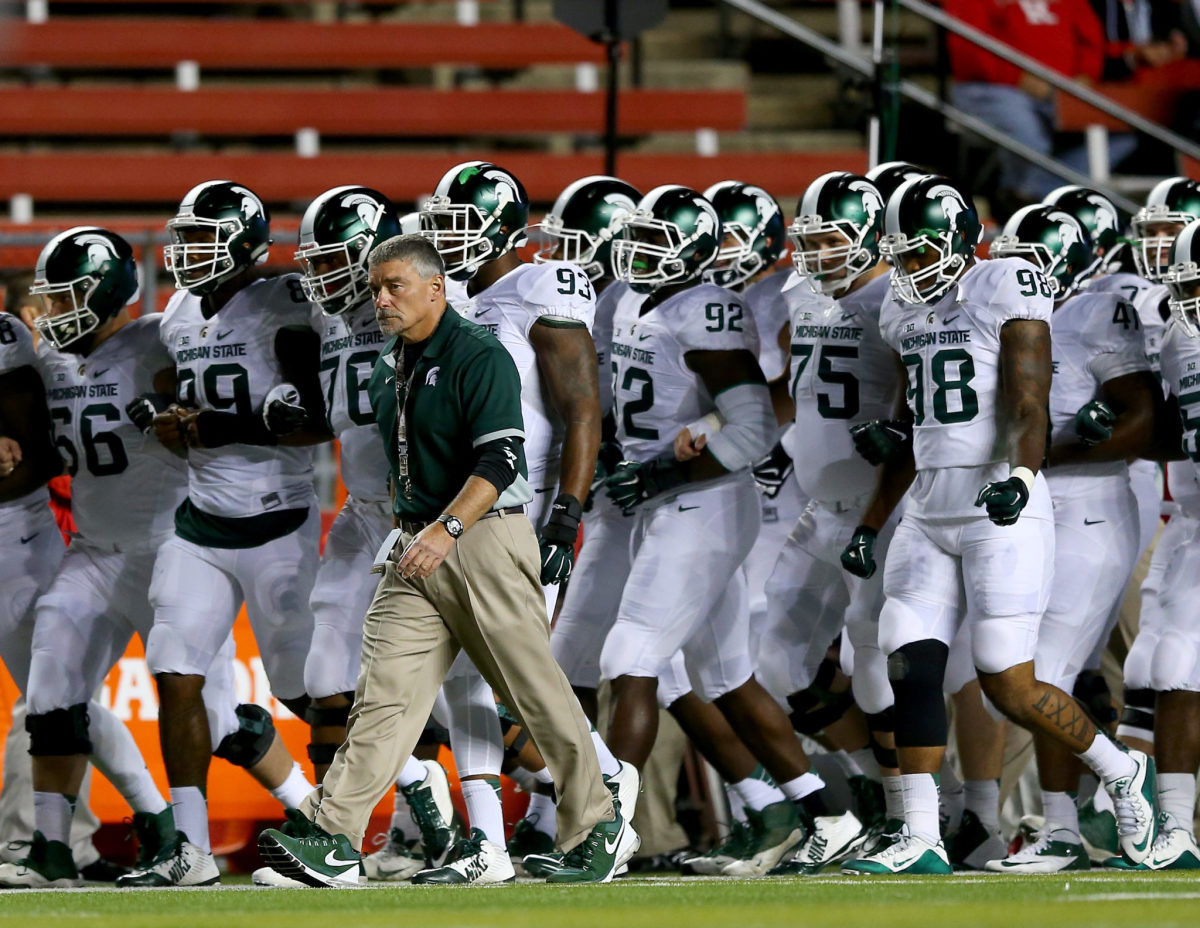 The Michigan State football team walking onto the field.