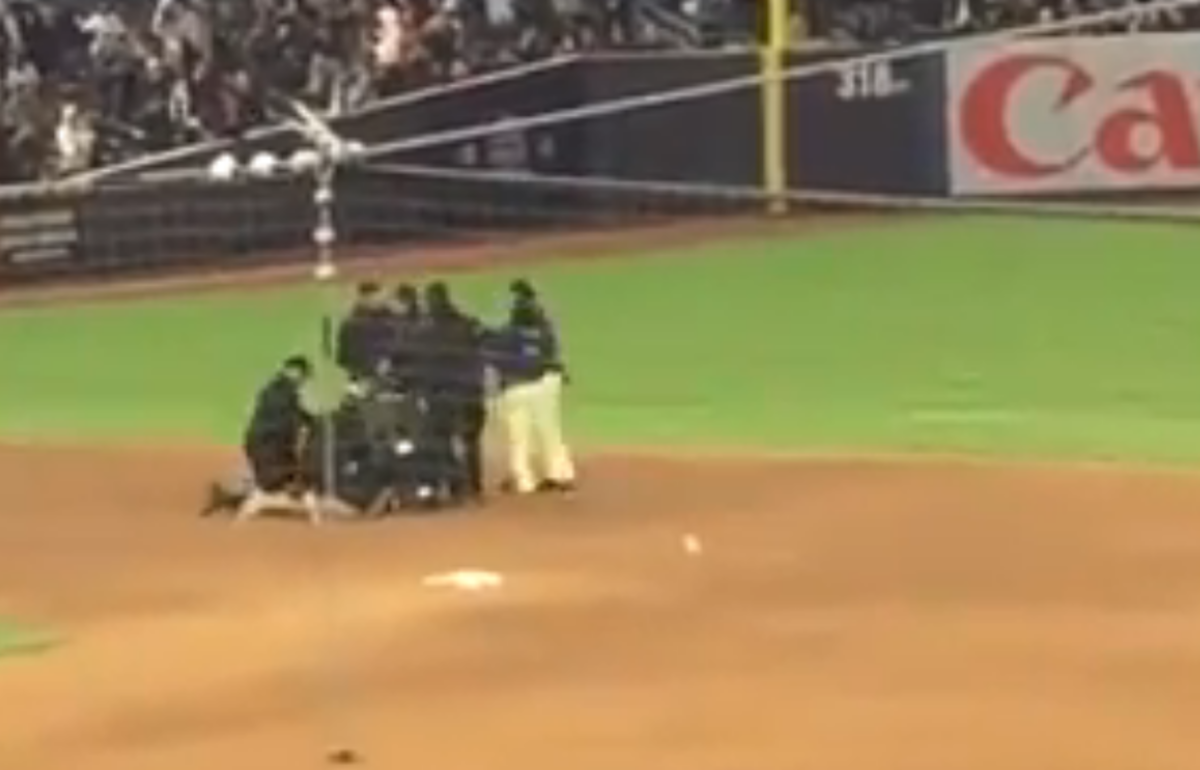 A yeankees fan gets tackled near second base